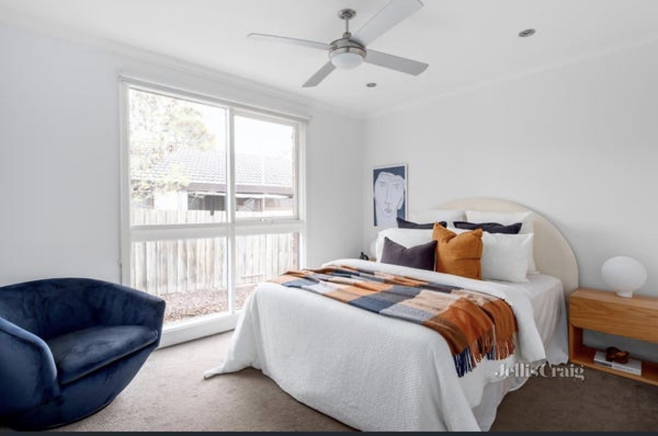 A bright bedroom at Viewbank House with garden views through large windows