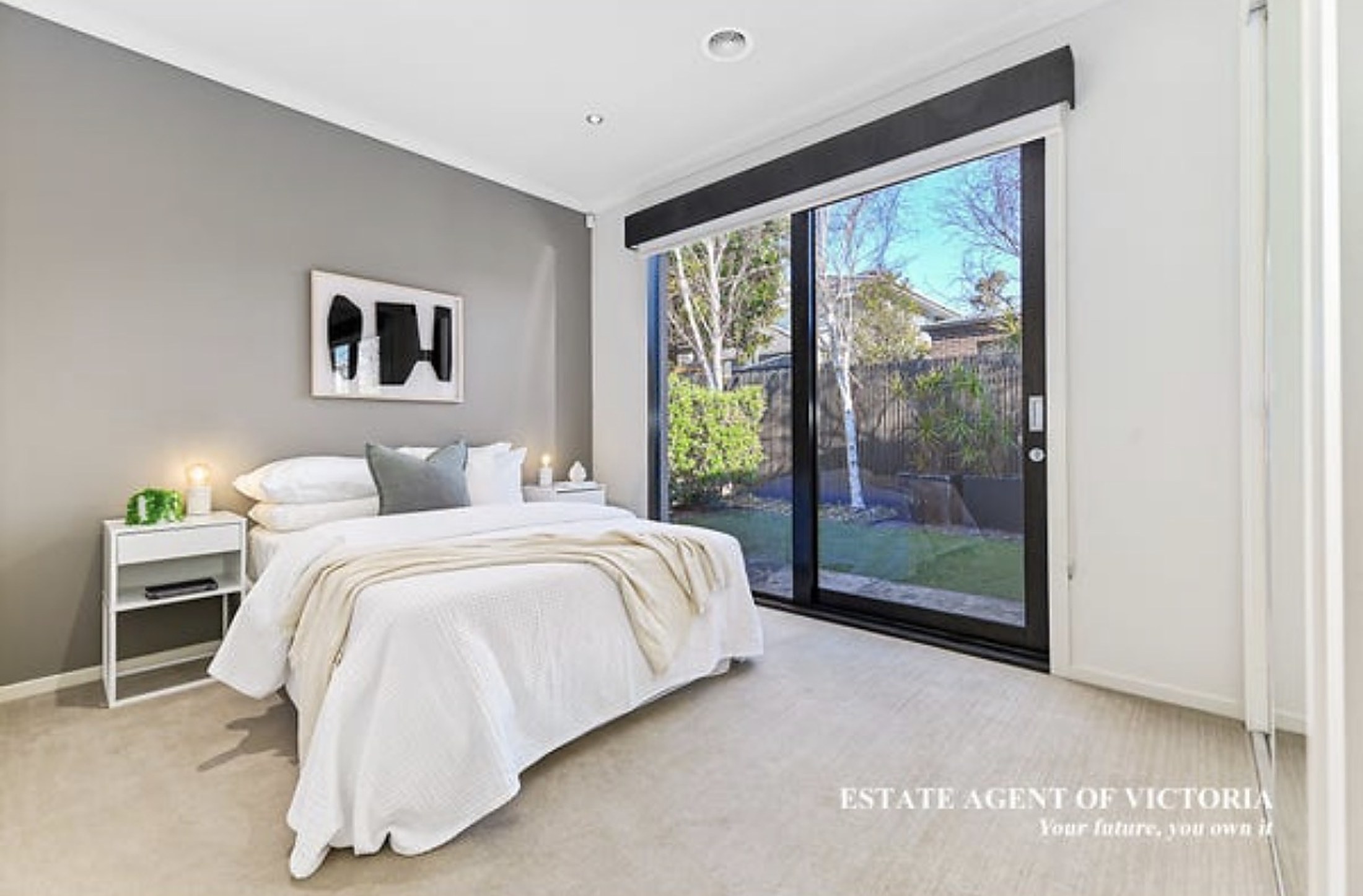 A bright bedroom at Clyde North House opening to the garden