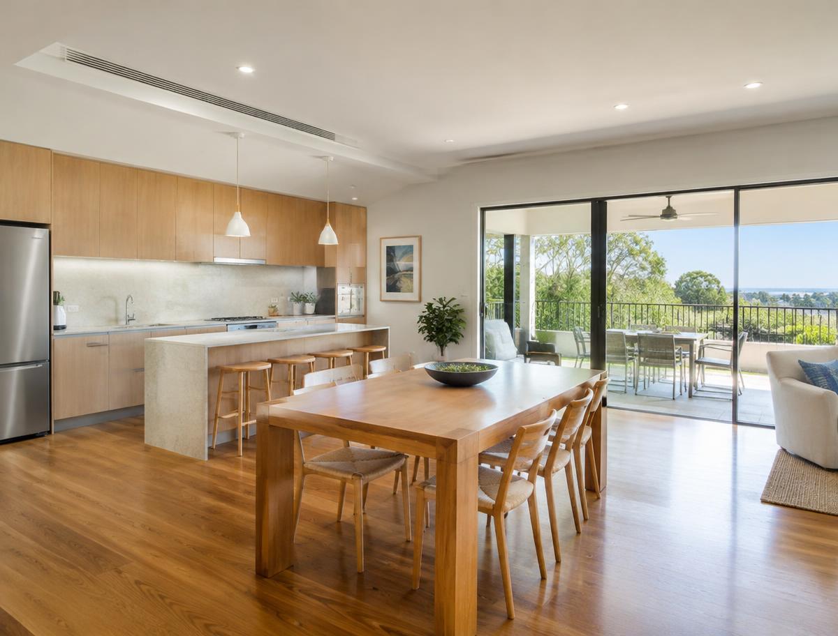 A bright, open-plan kitchen and dining area with wide walkways