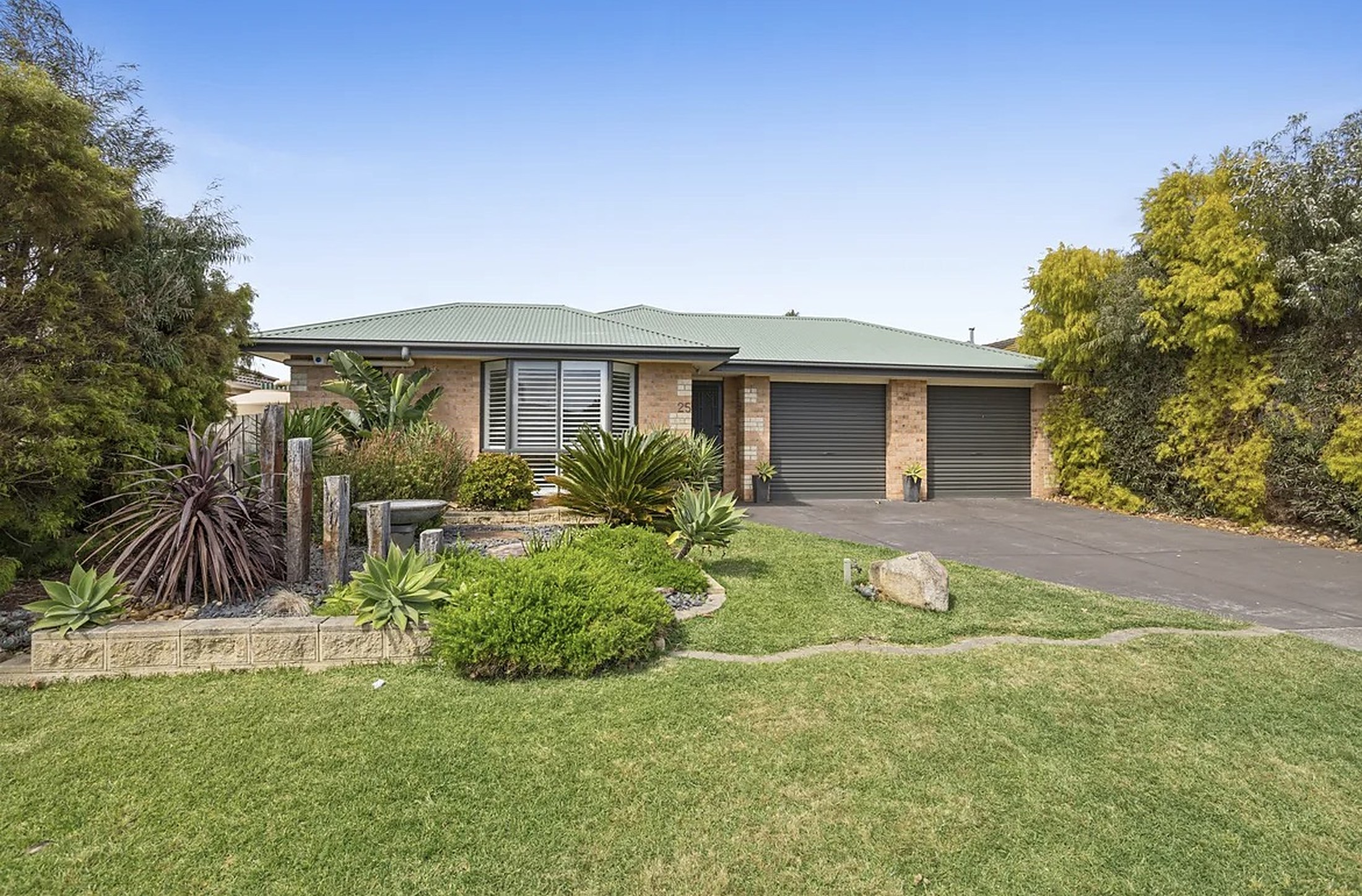 The front of Mornington House with its landscaped garden and driveway