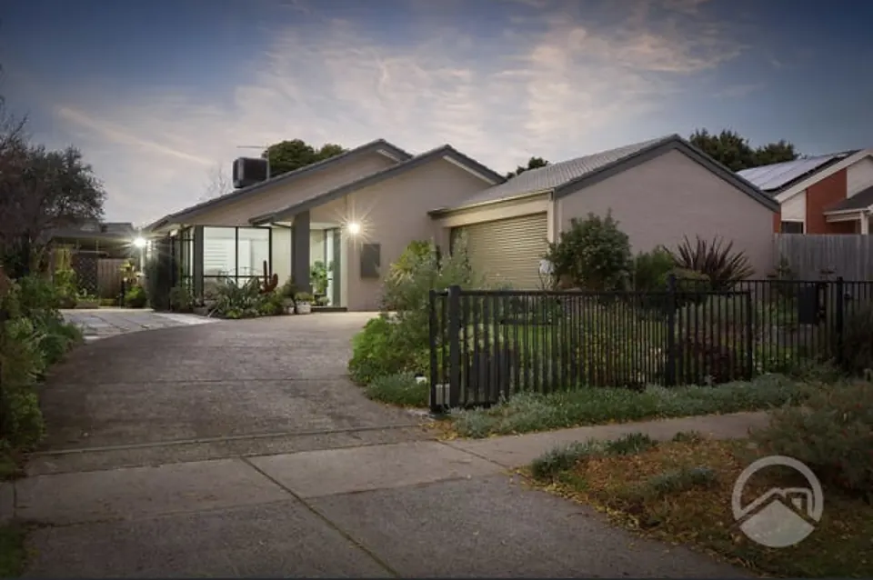 The front of Cranbourne North House at dusk, with its garden and driveway