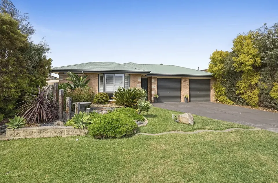 The front of Mornington House with its landscaped garden and driveway