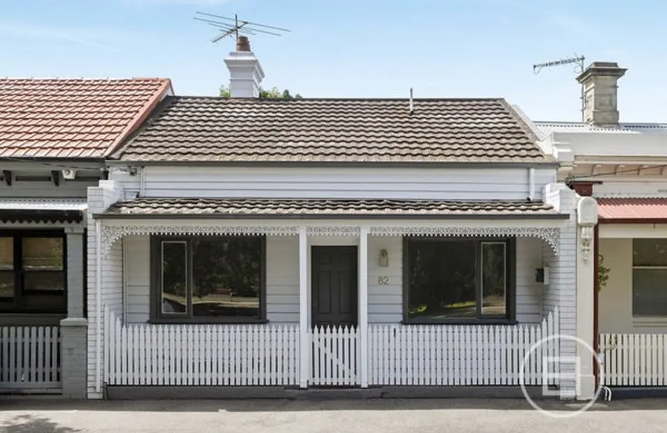 The front of Port Melbourne House, a classic Victorian terrace with a white picket fence