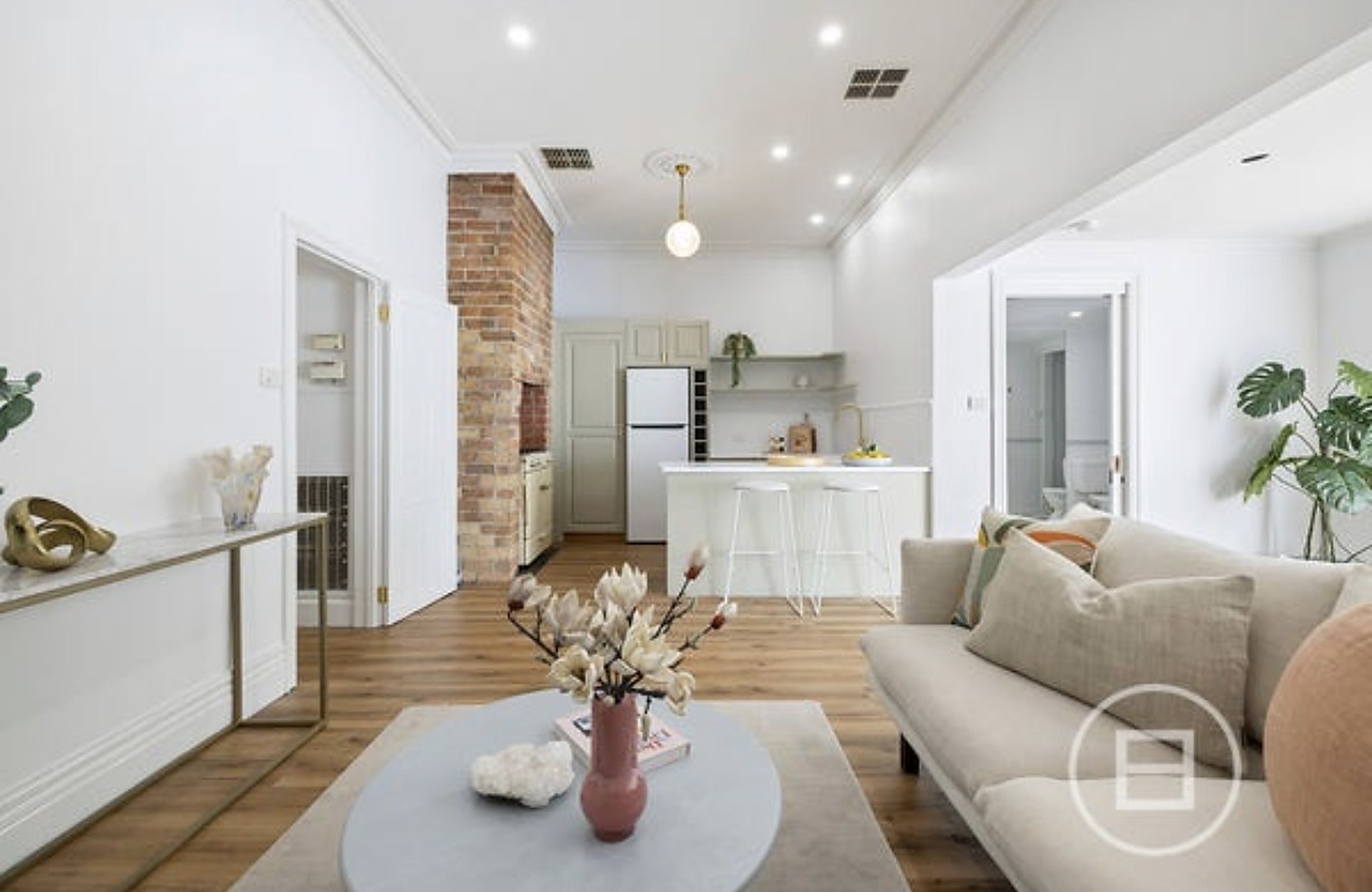 The bright open-plan living area and kitchen at Port Melbourne House