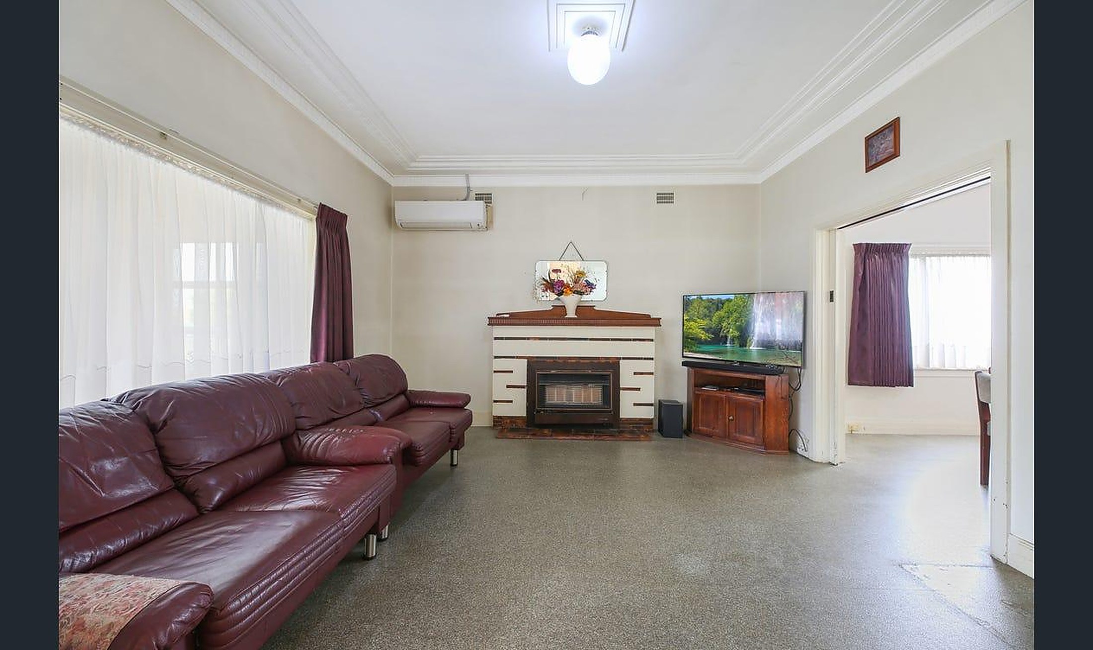 The living room at Warrigal House with sofas and a fireplace
